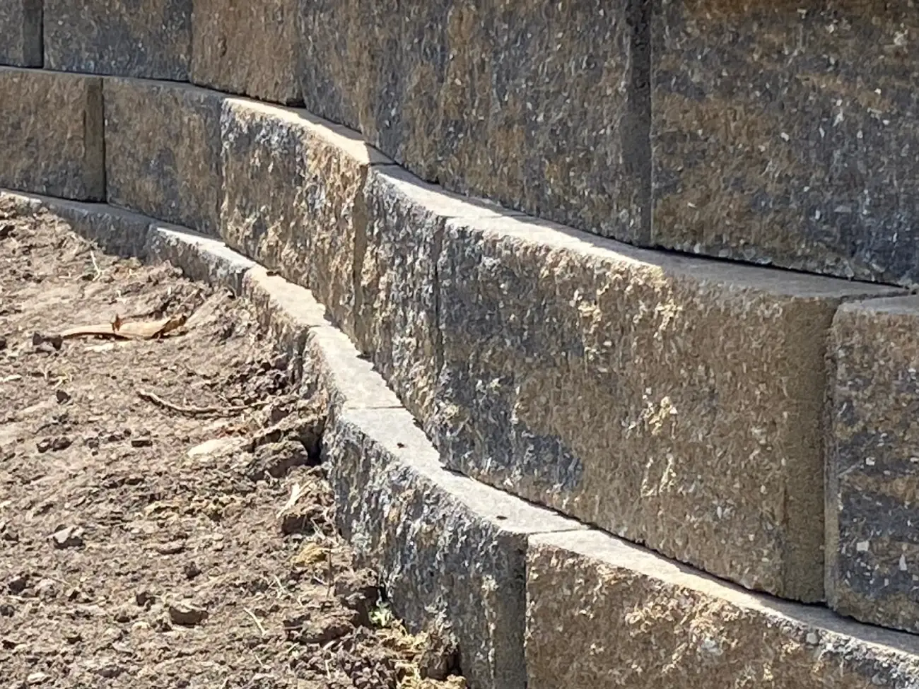 A close up of the side of a brick wall